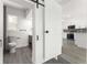 Bathroom featuring modern sliding door, toilet and sink, and a view of a kitchen at 4116 Winona Dr, Orlando, FL 32812
