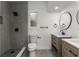 Well-lit bathroom with a modern vanity, toilet, and a tiled walk-in shower with contemporary fixtures at 4116 Winona Dr, Orlando, FL 32812