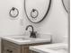 Close up on a bathroom vanity, faucet and round mirrors creating a welcoming and stylish space at 4116 Winona Dr, Orlando, FL 32812