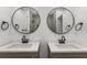 Bright bathroom featuring double sinks with modern fixtures, round mirrors, and ample countertop space at 4116 Winona Dr, Orlando, FL 32812