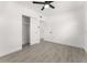Bright bedroom featuring gray tile floors, white walls, ceiling fan, and closet at 4116 Winona Dr, Orlando, FL 32812