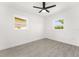 Bright bedroom featuring gray tile floors, white walls, and two windows at 4116 Winona Dr, Orlando, FL 32812
