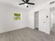 Bright bedroom featuring gray tile floors, white walls, and closet at 4116 Winona Dr, Orlando, FL 32812
