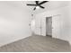 Bright bedroom featuring gray tile floors, white walls, ceiling fan, and closet at 4116 Winona Dr, Orlando, FL 32812