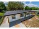 Stylish single-story home featuring a modern roof, fresh paint, and a welcoming front porch area at 4116 Winona Dr, Orlando, FL 32812