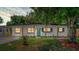 Charming single-story home featuring a well-maintained lawn, a vibrant teal door, and a covered front porch with wood pillars at 4116 Winona Dr, Orlando, FL 32812