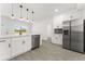 Spacious kitchen with stainless steel appliances, white cabinets, and ample counter space at 4116 Winona Dr, Orlando, FL 32812