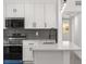 Bright kitchen with white cabinets, subway tile backsplash, and stainless steel appliances at 4116 Winona Dr, Orlando, FL 32812