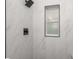 Updated shower featuring subway tile, matte black shower fixtures, and small window at 4116 Winona Dr, Orlando, FL 32812