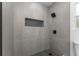 Modern tiled shower with a rainfall shower head and a convenient built-in niche for storage at 4116 Winona Dr, Orlando, FL 32812