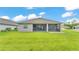 Charming home featuring a spacious, green backyard with a screened-in patio, perfect for relaxing at 7890 Lake James Blvd, Lakeland, FL 33810