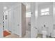 Modern bathroom with a walk-in shower, neutral tile, and updated fixtures at 7890 Lake James Blvd, Lakeland, FL 33810