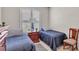 Bedroom featuring twin beds, neutral paint, and comfortable space at 7890 Lake James Blvd, Lakeland, FL 33810