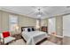 Bedroom with chandelier lighting, plantation shutters, hardwood floors, and ensuite bathroom at 7890 Lake James Blvd, Lakeland, FL 33810