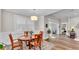 Dining room with wood table set on area rug, plantation shutters, and sliding glass door at 7890 Lake James Blvd, Lakeland, FL 33810