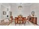 Formal dining room with a wooden table, seating for six, and decorative lighting at 7890 Lake James Blvd, Lakeland, FL 33810