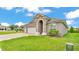 Elegant home boasts a stone-accented entrance, three-car garage, and meticulously maintained landscaping at 7890 Lake James Blvd, Lakeland, FL 33810