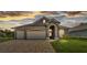 Beautiful single-story home with stone accents, three-car garage and manicured lawn at 7890 Lake James Blvd, Lakeland, FL 33810