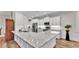 Modern kitchen featuring white cabinets, stainless steel appliances, and a large center island at 7890 Lake James Blvd, Lakeland, FL 33810