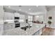 Bright kitchen featuring granite counters, white cabinets, stainless appliances, and pendant lighting at 7890 Lake James Blvd, Lakeland, FL 33810
