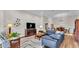 Comfortable living room featuring a plush sectional sofa, hardwood floors, and modern decor at 7890 Lake James Blvd, Lakeland, FL 33810