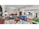 Open-concept living area with a modern sectional sofa and an adjacent kitchen with white cabinets at 7890 Lake James Blvd, Lakeland, FL 33810