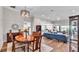 Open-concept living room and dining area with hardwood floors and a modern light fixture at 7890 Lake James Blvd, Lakeland, FL 33810