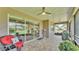 Covered porch features comfortable seating, outdoor kitchen, and serene views at 7890 Lake James Blvd, Lakeland, FL 33810