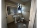 Bathroom featuring a pedestal sink and a toilet with visible damages and overall in disrepair at 801 Quintilian Ave, Orlando, FL 32809