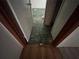 Damaged flooring transitions from wood to tile and shows disrepair and possible water damage at 801 Quintilian Ave, Orlando, FL 32809