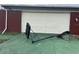 Garage with an old basketball hoop lying on the ground in need of repair at 801 Quintilian Ave, Orlando, FL 32809