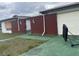 A closer side angle of a modest, single story home with brick and siding and garage at 801 Quintilian Ave, Orlando, FL 32809
