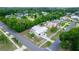 This is an aerial view of a home with a light colored roof, a manicured lawn, and mature trees in the neighborhood at 1161 Orangewood Ave, Deland, FL 32724