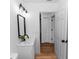 This is a bathroom with a white vanity, a black faucet and mirror, and a modern light fixture at 1161 Orangewood Ave, Deland, FL 32724