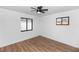 Clean bedroom featuring updated flooring, two windows and a modern ceiling fan at 1161 Orangewood Ave, Deland, FL 32724