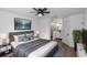 Comfortable bedroom with ceiling fan, ensuite bath, and hardwood flooring at 1161 Orangewood Ave, Deland, FL 32724