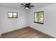 Empty bedroom with wood-look flooring, a ceiling fan, and dual-pane windows at 1161 Orangewood Ave, Deland, FL 32724