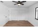 Spacious bedroom with two closets, a ceiling fan and modern vinyl plank flooring at 1161 Orangewood Ave, Deland, FL 32724
