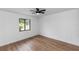 This is an empty bedroom with hardwood floors and a window with a neighborhood view at 1161 Orangewood Ave, Deland, FL 32724