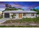 Charming home featuring a metal roof, freshly painted exterior, updated landscaping and an attached garage at 1161 Orangewood Ave, Deland, FL 32724