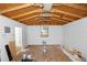 This is an unfinished garage with exposed rafters and a small window at 1161 Orangewood Ave, Deland, FL 32724