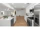 Bright, modern kitchen featuring white cabinets, stainless appliances, quartz countertops, and pendant lighting at 1161 Orangewood Ave, Deland, FL 32724