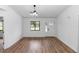 Bright living room with wood-look floors and a modern front door at 1161 Orangewood Ave, Deland, FL 32724