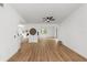 Open-concept living area with wood-look flooring and white walls with black trim at 1161 Orangewood Ave, Deland, FL 32724