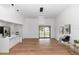 Bright living room featuring modern light fixture, vaulted ceilings, and stylish flooring with sliding glass doors at 1161 Orangewood Ave, Deland, FL 32724