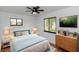Brightly decorated main bedroom with modern decor, ceiling fan, and an en suite bathroom at 1161 Orangewood Ave, Deland, FL 32724