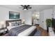 Comfortable main bedroom suite with modern ceiling fan, ensuite bath with a tiled shower, and walk-in closet at 1161 Orangewood Ave, Deland, FL 32724