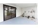 This is a screened patio area with a sliding glass door and a gray painted floor at 1161 Orangewood Ave, Deland, FL 32724