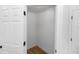 Bright walk-in closet with modern wood-look vinyl flooring and white walls at 1161 Orangewood Ave, Deland, FL 32724
