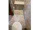 Bathroom featuring a tiled floor, toilet, and partial view of shower at 2220 Woods Trl, Lakeland, FL 33809
